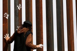 Activist paints the U.S.-Mexico border wall between Ciudad Juarez and New Mexico as a symbol of protest against U.S. President Donald Trump''s new immigration reform in Ciudad Juarez, Mexico
