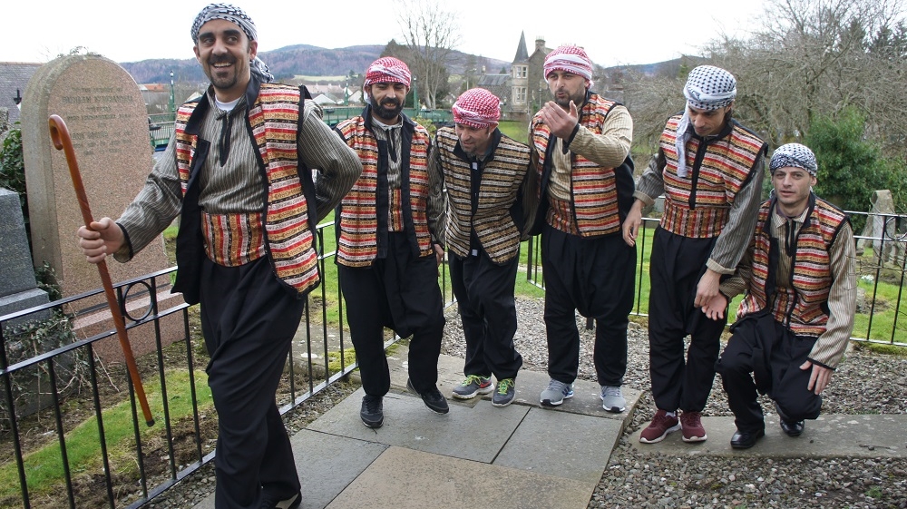 A group of Syrian dabke dancers practise their routine outside the White Church Community Centre in Comrie [Zab Mustefa/Al Jazeera]