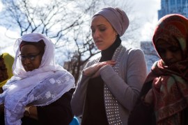 Women take part in a prayer at one Saint Andrews Plaza in Lower Manhattan, New York