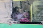 A girl rides a bus to be evacuated from a rebel-held sector of eastern Aleppo, Syria, December 18, 2016 [Abdalrhman Ismail/Reuters]