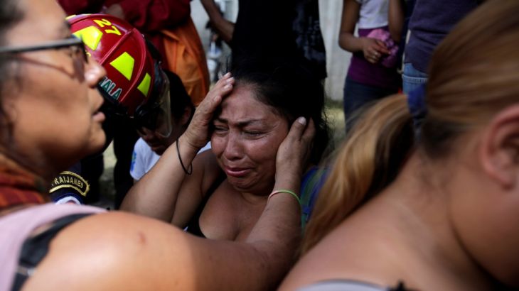 Family members react as they wait for news of their loved ones after a fire broke at the Virgen de Asuncion home in San Jose Pinula