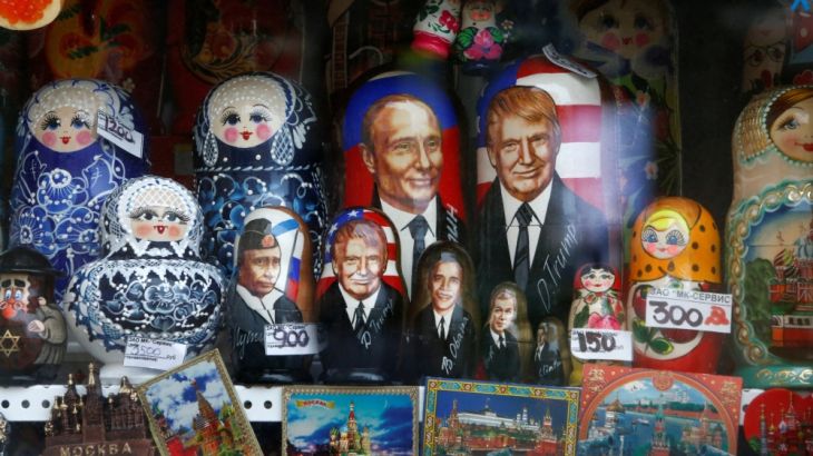 Russian traditional Matryoshka wooden dolls with images of Russian President Putin and U.S. President Trump are on sale at a gift kiosk in a street in Moscow