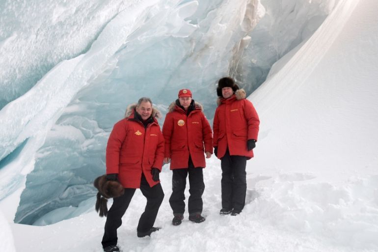 Russian President Putin, PM Medvedev and Defence Minister Shoigu pose for a picture during visit to cave of Arctic Pilots Glacier in Alexandra Land in remote Arctic islands of Franz Josef Land