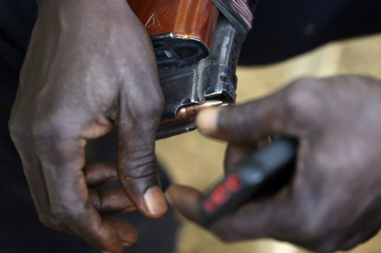 Leader of militia hunters helping the army to fight the Boko Haram insurgence in the northeast region of Nigeria, holds a magazine of bullets in his hands during an interview in Yola