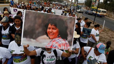 A protester holds up a picture of slain environmental rights activist Berta Caceres [File: Jorge Cabrera/Reuters] 