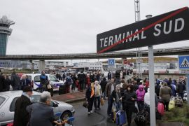 Passengers wait at Orly airport southern terminal after shooting incident near Paris