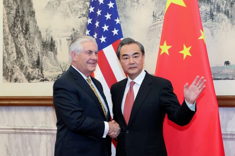 Chinese Foreign Minister Wang Yi shakes hands with U.S. Secretary of State Rex Tillerson at Diaoyutai State Guesthouse in Beijing