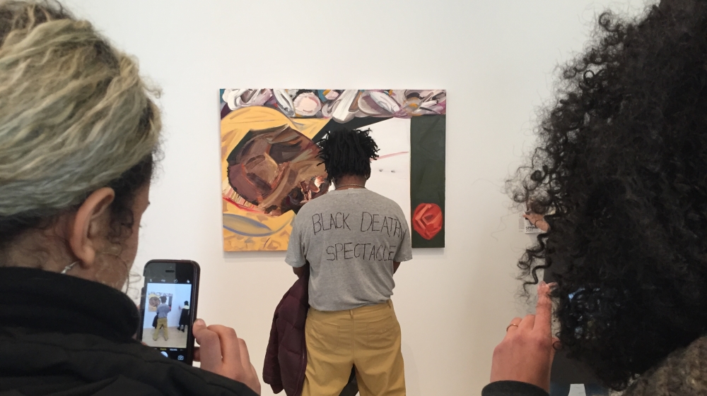  Parker Bright, an African American artist, is protesting against the painting by partially blocking it from view [Michael Bilsborough]