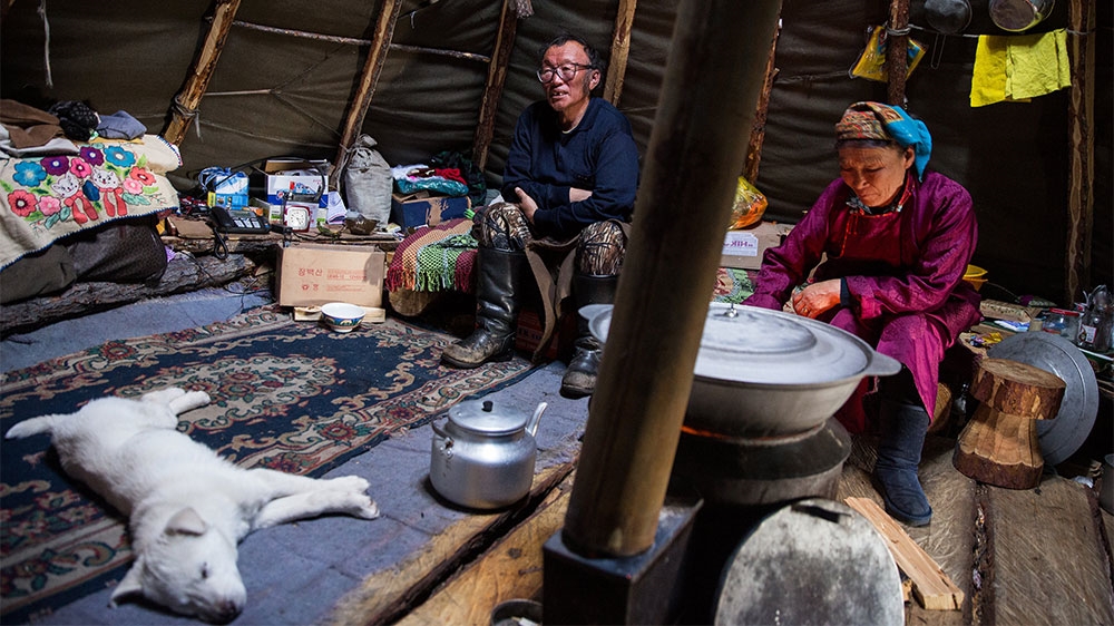 Uwugdorj Delger, a former ranger and a Dukha, at home with his wife. [Taylor Weidman/Al Jazeera]