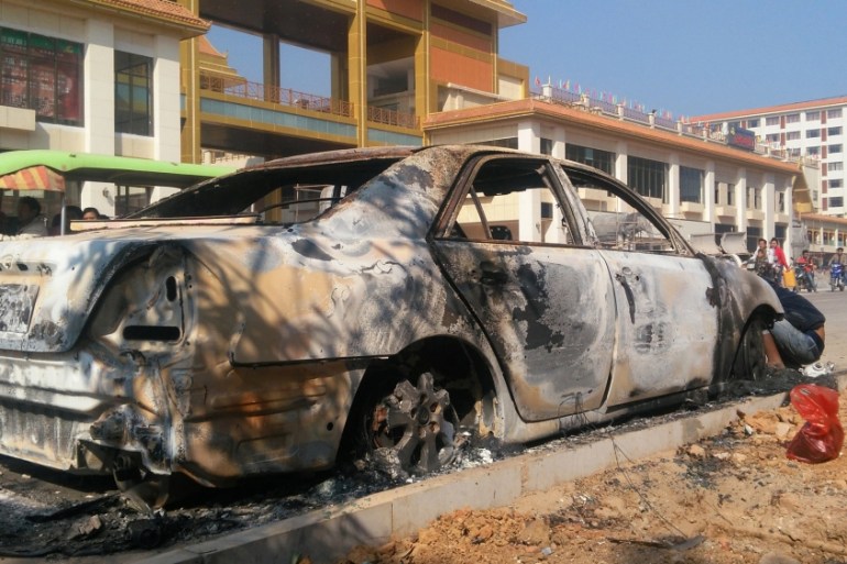 A burnt car is seen after fighters of the Myanmar National Democratic Alliance Army launched an attack on March 6 on police, military, and government sites in Laukkai