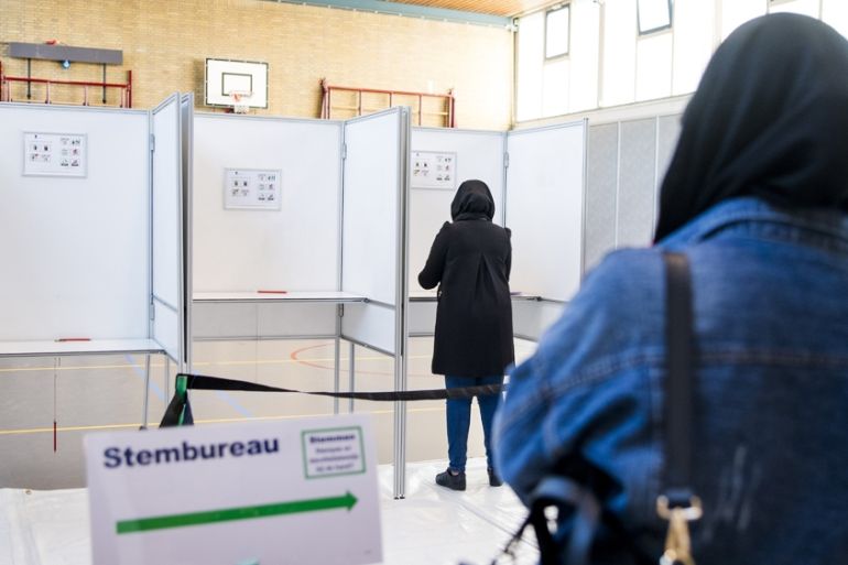 People get ready to cast their vote as part of the Dutch general election