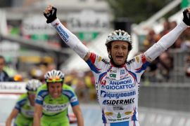FILE PHOTO: Androni-Diquigiova team rider Scarponi celebrates winning the 19th stage of the Giro d''Italia cycling race