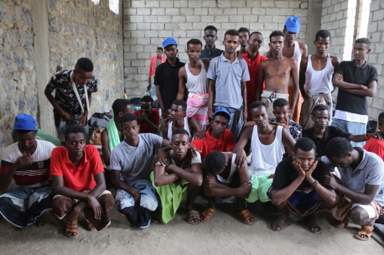 Somali refugees who survived an attack on a boat off Yemen''s coast in the Red Sea pose for a group photo as they wait at a detention center in the Houthi-held port of Hodeidah, Yemen