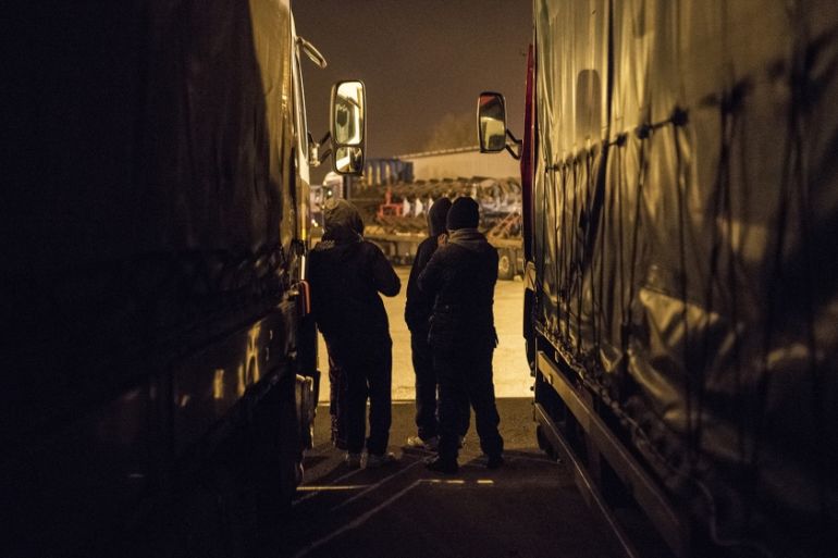 Young refugees in Calais wait before attempting to slip into trucks at the truck stop