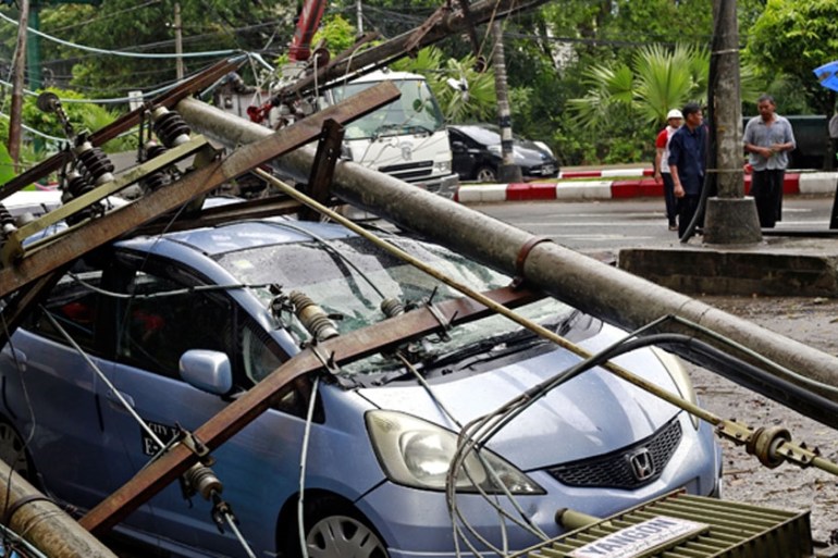 A utility pole fallen onto a car in Yangon, Myanmar.
