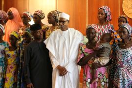 Some of the 21 Chibok schoolgirls released by Boko Haram pose during a group photograph with President Muhammadu Buhari and Vice President Yemi Osinbajo In Abuja, Nigeria
