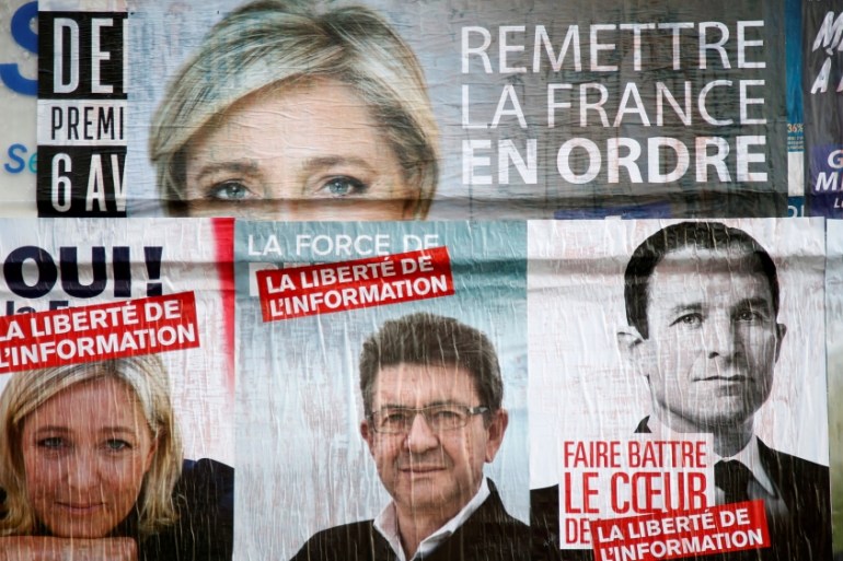 FILE PHOTO: Campaign posters for candidates Marine Le Pen of the National Front (FN), Jean-Luc Melenchon of the Parti de Gauche, and Benoit Hamon of the Socialist Party are seen in Paris