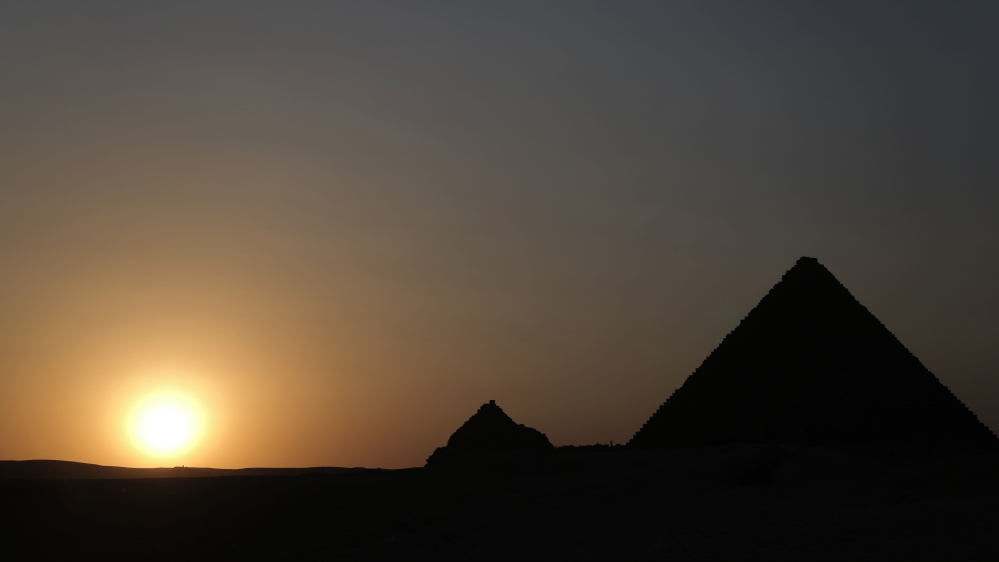 The sun sets over the Great Pyramids of Giza in November 2016 [Dorian Geiger/Al Jazeera]