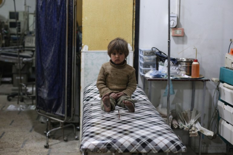 Injured poeple receive treatment after bombing Douma