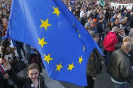 A woman holds European Union flag during a protest in Heroes’ square against a new law that would undermine Central European University in Budapest