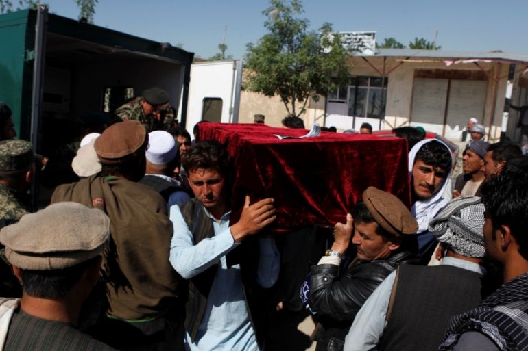Relatives carry the coffin of one of the victims a day after an attack on an army headquarters in Mazar-i-Sharif
