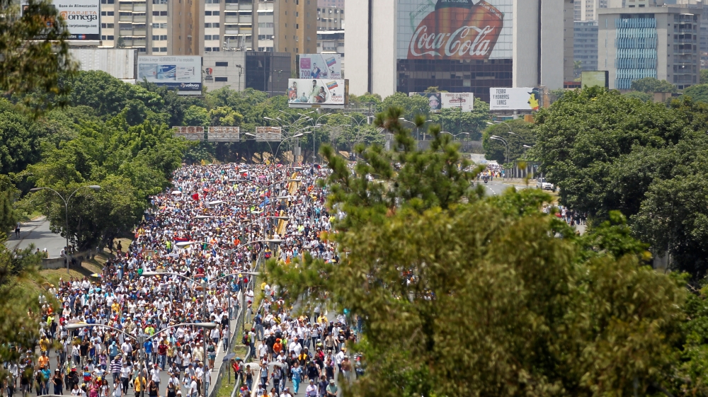 Protesters say Maduro is taking Venezuela down the path of dictatorship [Christian Veron/Reuters]