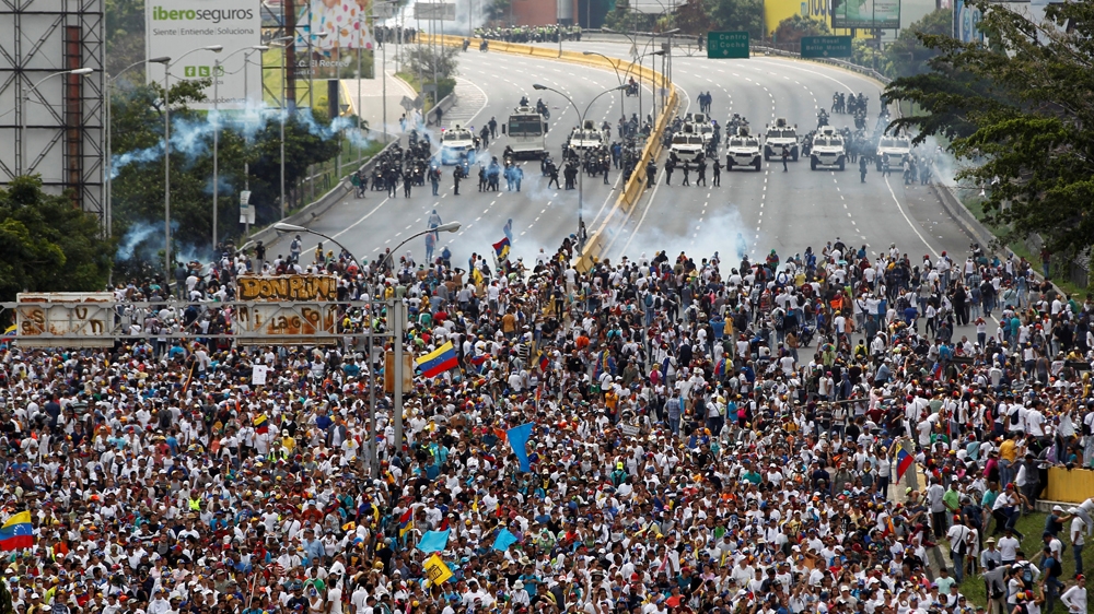 Hundreds of thousands marched against President Maduro in Caracas [Christian Veron/Reuters]