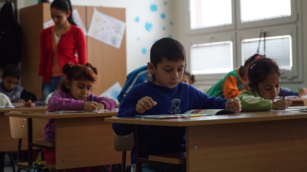 Most schools do not allow Roma children to take their textbooks home with them, in case they are used to make fires during the winter in homes that have no heating [Sorin Furcoi/Al Jazeera]
