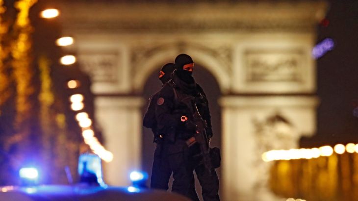 French police stand on their vehicle after an attack in the Champs Elysees in Paris