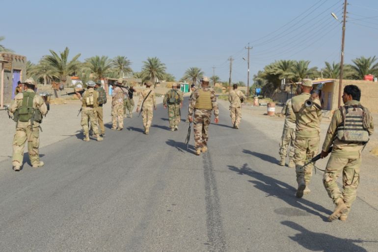 Iraqi army soldiers patrol in the town of Hit in Anbar province