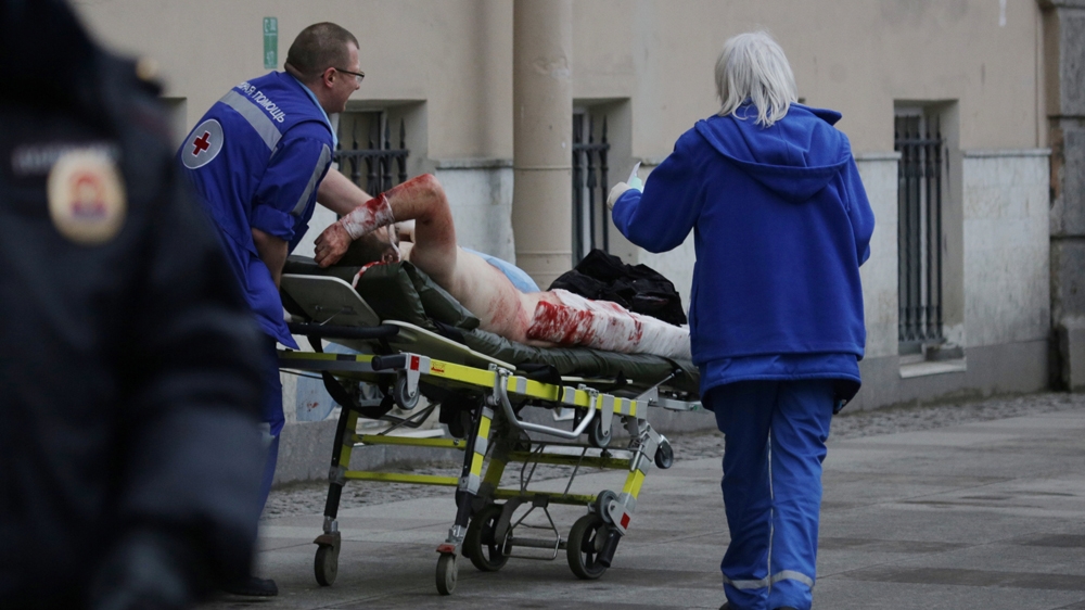 A wounded man is helped by emergency services in St Petersburg [Anton Vaganov/Reuters]