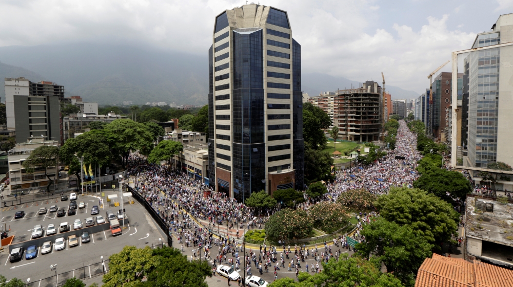 Opposition supporters rally in Caracas on Thursday [Marco Bello/Reuters]