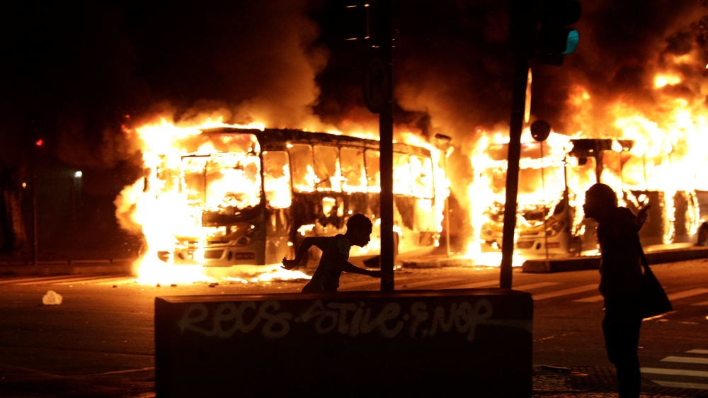 Buses burn during Friday's demonstrations in Rio de Janeiro [Ricardo Moraes/Reuters]