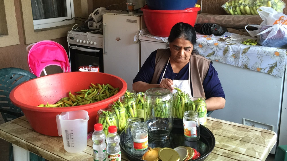 Meneshka Umjer pickles peppers in Shutka [Valerie Hopkins/Al Jazeera]