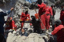 Iraqi firefighters look for bodies buried under the rubble, of civilians who were killed after an air strike against Islamic State triggered a massive explosion in Mosul
