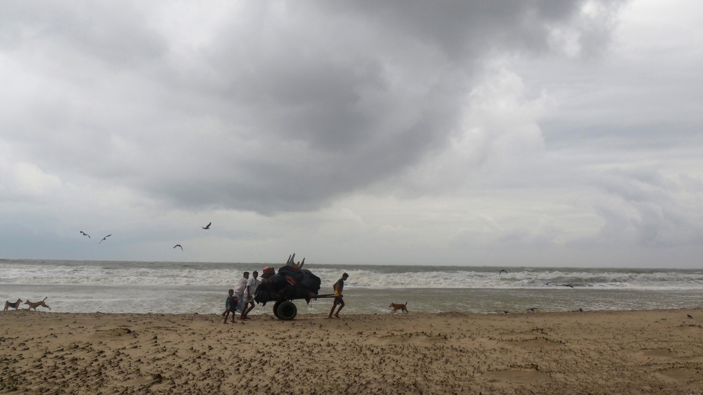Bangladeshi villagers evacuate to cyclone shelters on the coast on Monday [AFP]