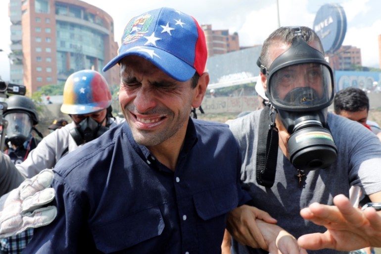 Venezuela opposition leader and Governor of Miranda state Capriles reacts as he is affected by tear gas while rallying against Venezuela''s President Maduro in Caracas