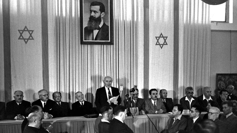 David Ben Gurion, centre, a Polish Jew, reads out what Israel called a declaration of independence on May 14, 1948. A photo of Herzl hangs in the backdrop [Reuters]