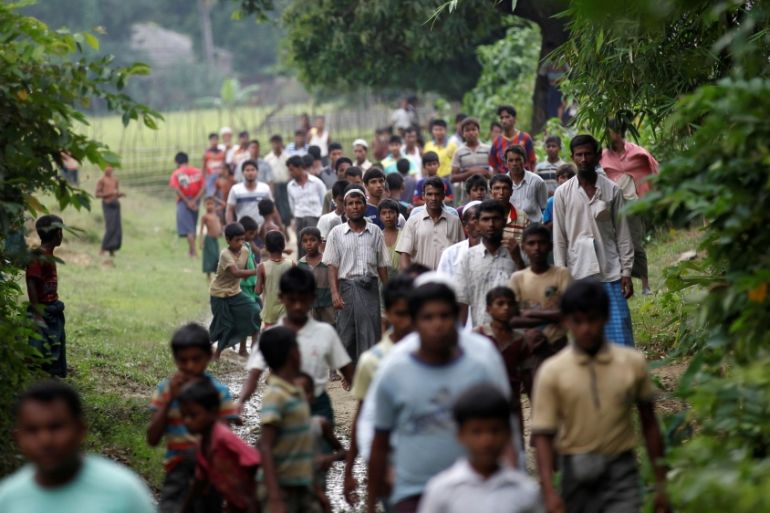 FILE PHOTO: Men walk at a Rohingya village outside Maugndaw in Rakhine state