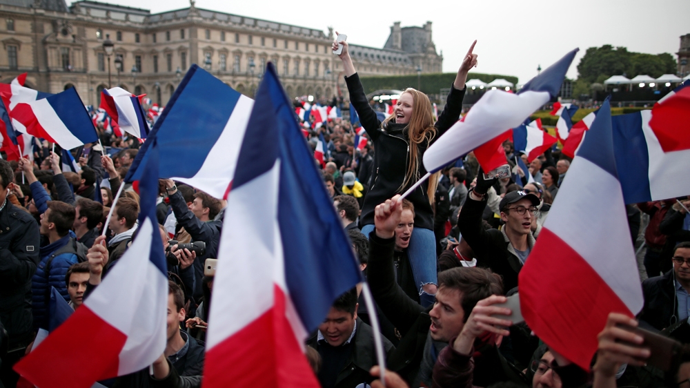 Supporters of Emmanuel Macron celebrate near the Louvre museum after results were announced on Sunday [Benoit Tessier/Reuters]