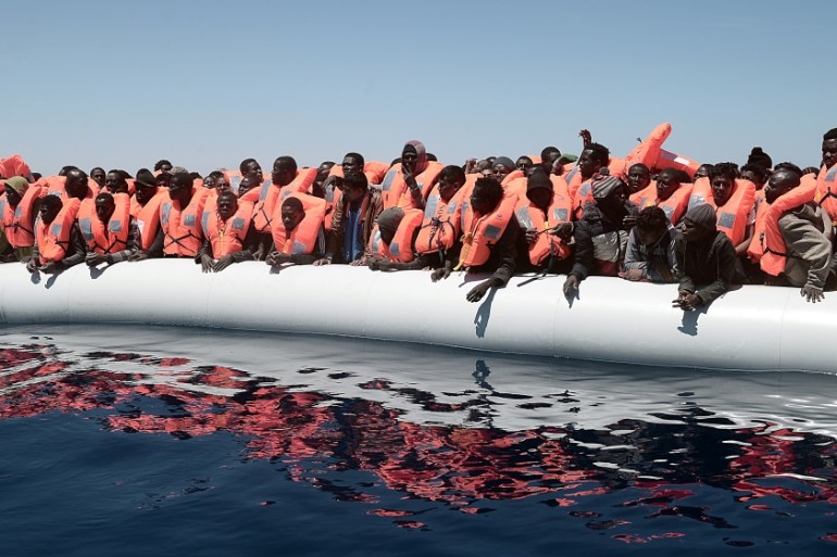 A plastic raft overcrowded with migrants is seen drifting during a search and rescue operation by rescue ship Aquarius, operated by SOS Mediterranean and Doctors without Borders