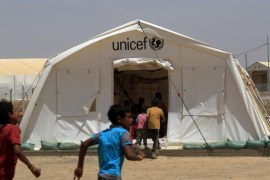 Displaced Iraqi boys enter a tent school set by UNICEF at Hammam al-Alil camp south of Mosul