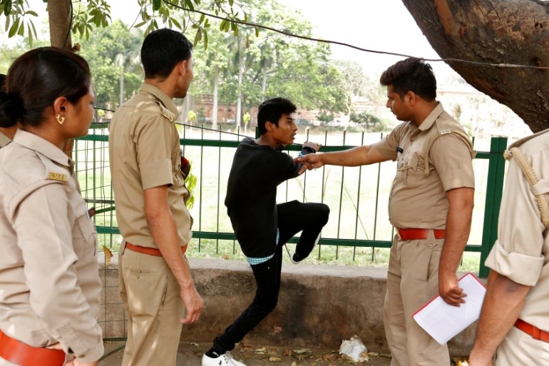 The "Anti-Romeo Squad" question a youth following regulations imposed by newly elected Uttar Pradesh State Chief Minister, Yogi Adityanath, in Lucknow