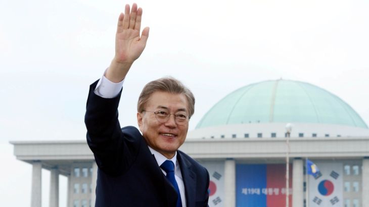 South Korean President Moon Jae-in waves as he leaves the National Cemetery after inaugural ceremony in Seoul