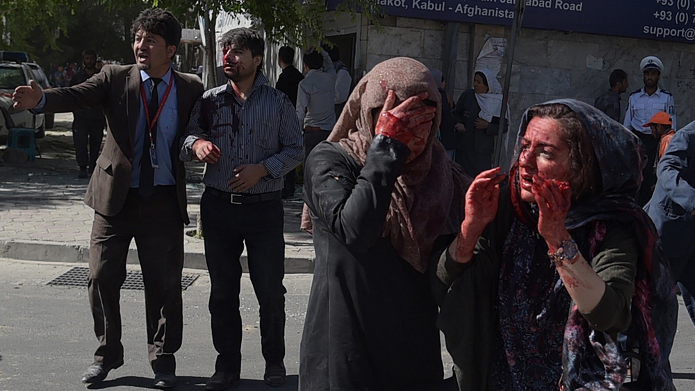 Wounded Afghan women and men at the site of a truck bomb attack in Kabul's diplomatic district [Shah Marai/AFP] 
