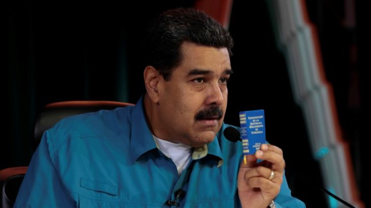 Venezuela''s President Nicolas Maduro holds a copy of the Venezuelan constitution as he speaks during his weekly broadcast "Los Domingos con Maduro" (The Sundays with Maduro) in Caracas