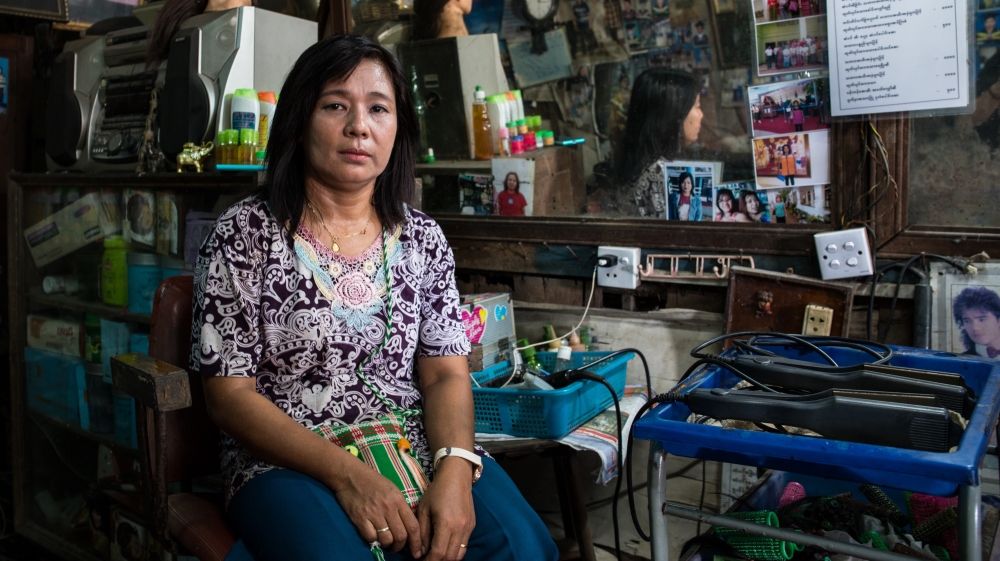 Win Win Moe in her beauty salon which has benefitted from a low-interest loan from the Dawna Street collective savings group [Katie Arnold/Al Jazeera]
