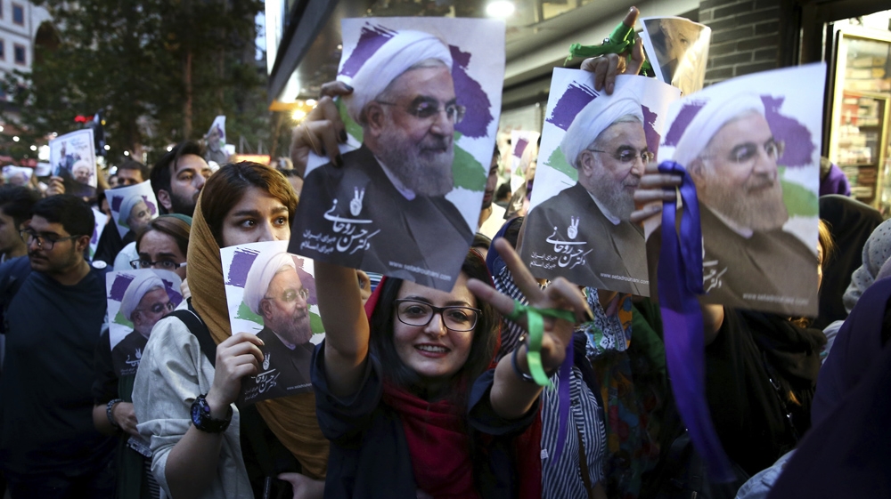 Tens of thousands poured into the streets of Tehran to celebrate Rouhani's win [Ebrahim Noroozi/AP]