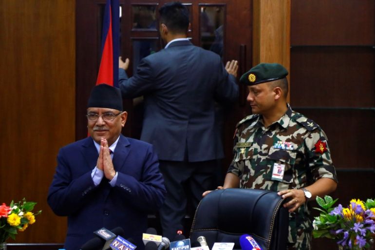 Nepalese PM Pushpa Kamal Dahal, also known as Prachanda, greets media upon his arrival to announce his resignation in Kathmandu