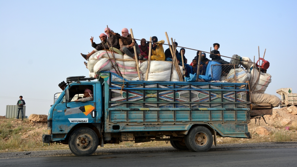 People ride on trucks as they flee Raqqa city amid increased coalition bombing and as SDF forces advance [Youssef Rabie Youssef/EPA]